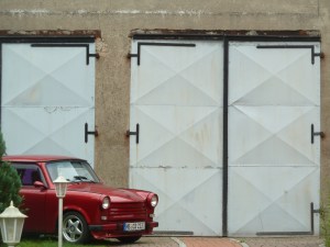 restored Trabant in eastern Germany outside a classic old farmhouse gate. Dragging the old into the now